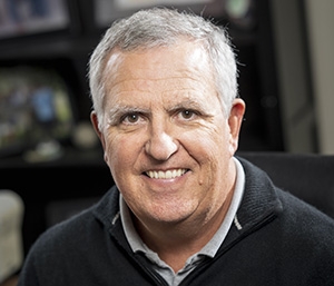 Portrait photo of older man with white hair