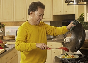 Martin Yan plates stir fry made in his first wok.