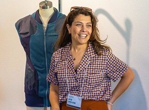 Gozde Goncu-Berk, a Chancellor's Fellow wearing a namebadge on a lanyard in in front of a mannequin with an outfit on it.