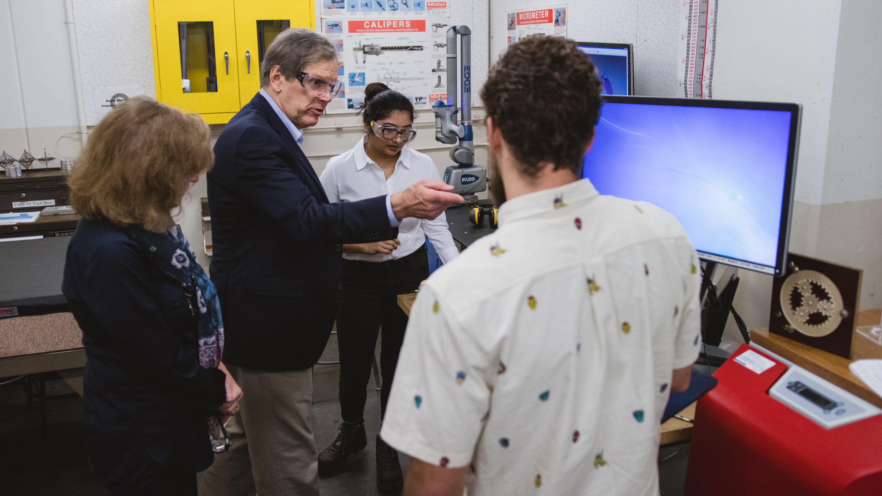 John and Mindy Baum talking with UC Davis students in a lab